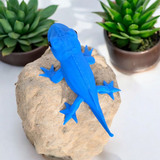 Détail d'une figurine de gecko à la surface texturée et au profil charmant