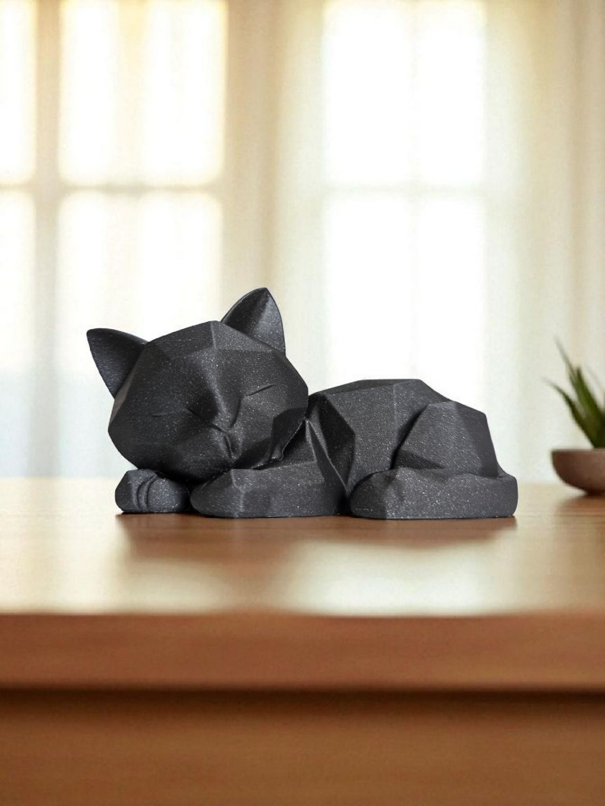 Détail des formes géométriques d'une sculpture de chaton endormi