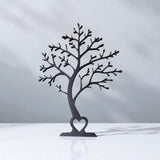 Arbre décoratif minimaliste en silhouette, vu de face, aux lignes de branches épurées