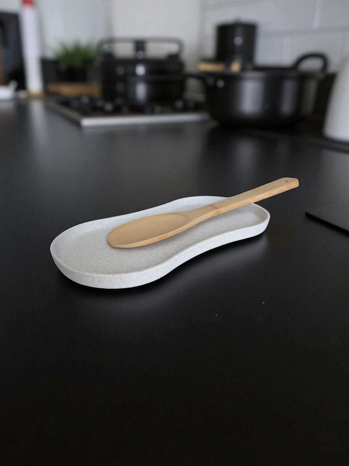 Porte-cuillères sur le plan de travail avec une spatule en bois et une louche