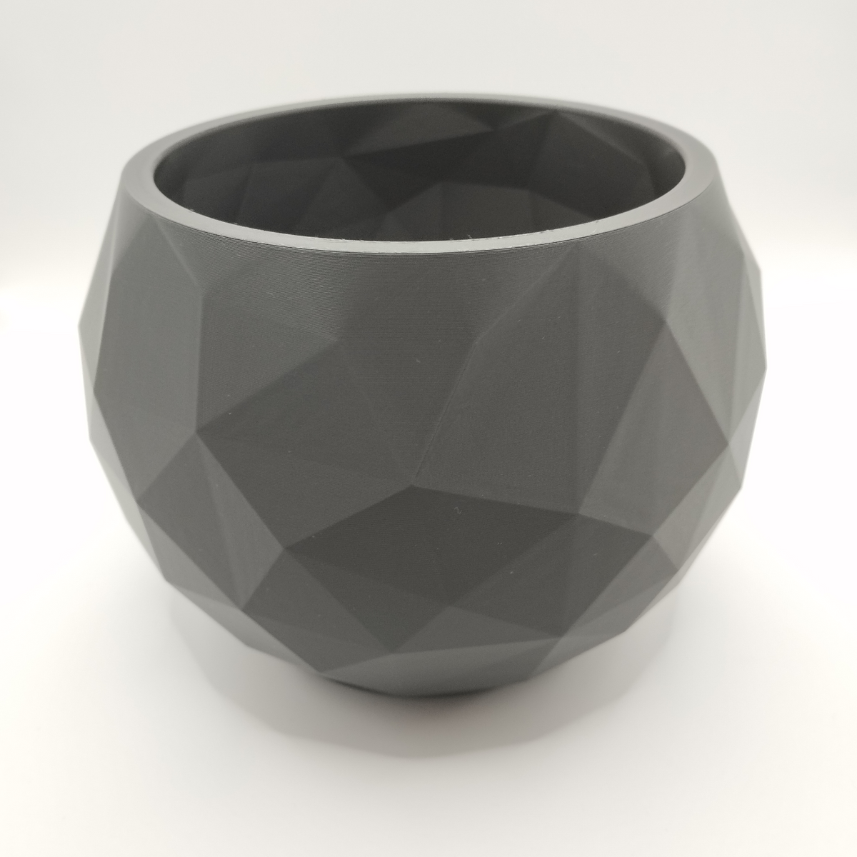 Coupe low poly sur une étagère blanche avec une déco minimaliste dans un doux intérieur nordique