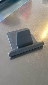 Support de tablette blanc minimaliste vu de profil, à la forme et à l'angle géométriques