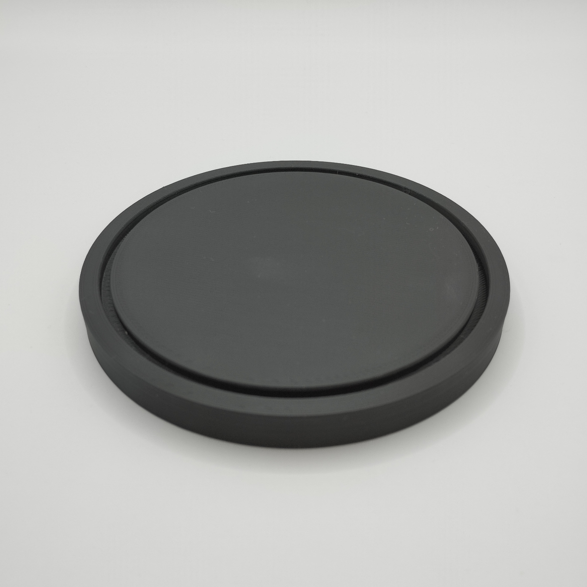 Sous-verre rond minimaliste sous une tasse chaude en céramique sur une table en bois