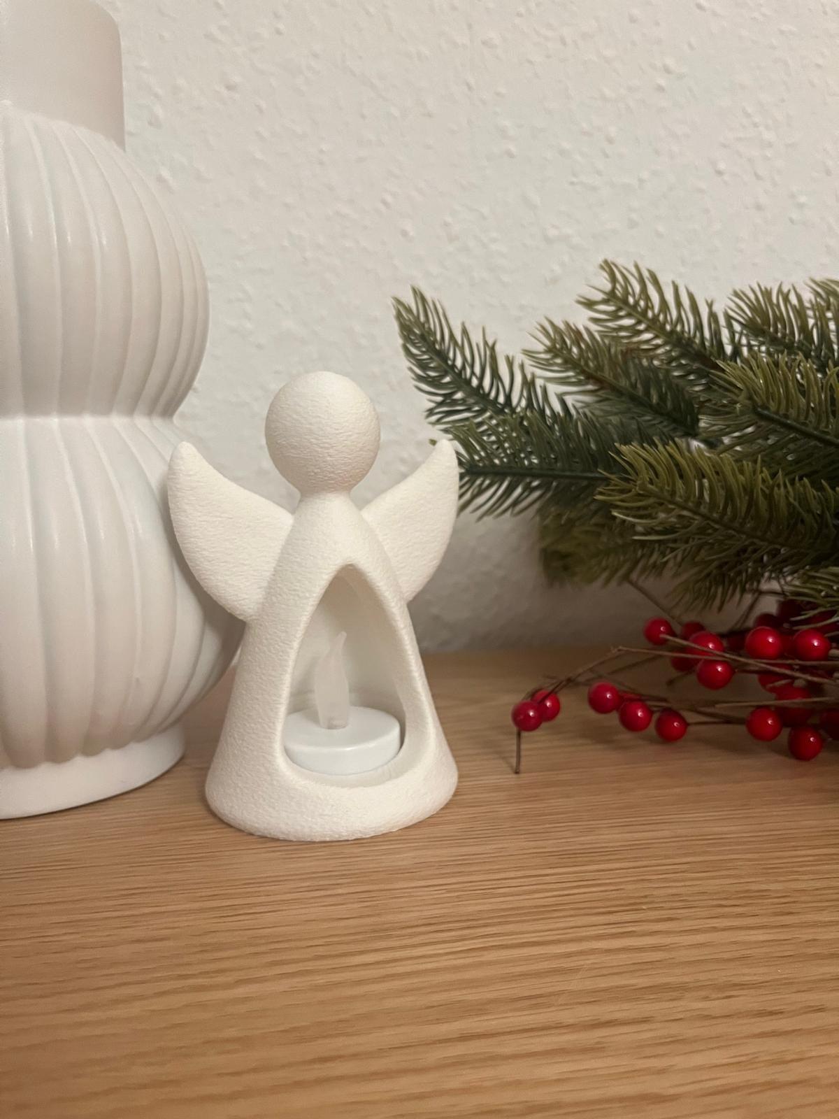 Figurine d'ange avec bougie LED qui l'éclaire de l'intérieur