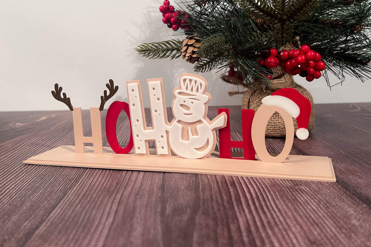 Décoration de Noël avec l'inscription Ho Ho Ho en quatre couleurs