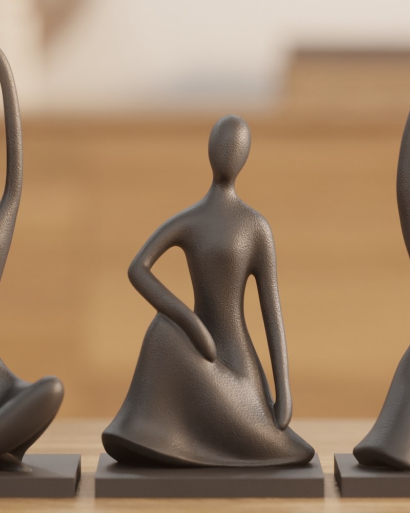 Trois figurines humaines abstraites à finition mate réunies sur une surface blanche