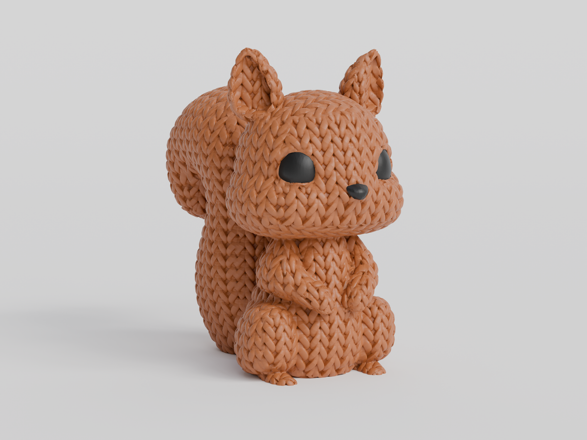 Gros plan d'une figurine d'écureuil tricoté, aspect crocheté et petits yeux de verre