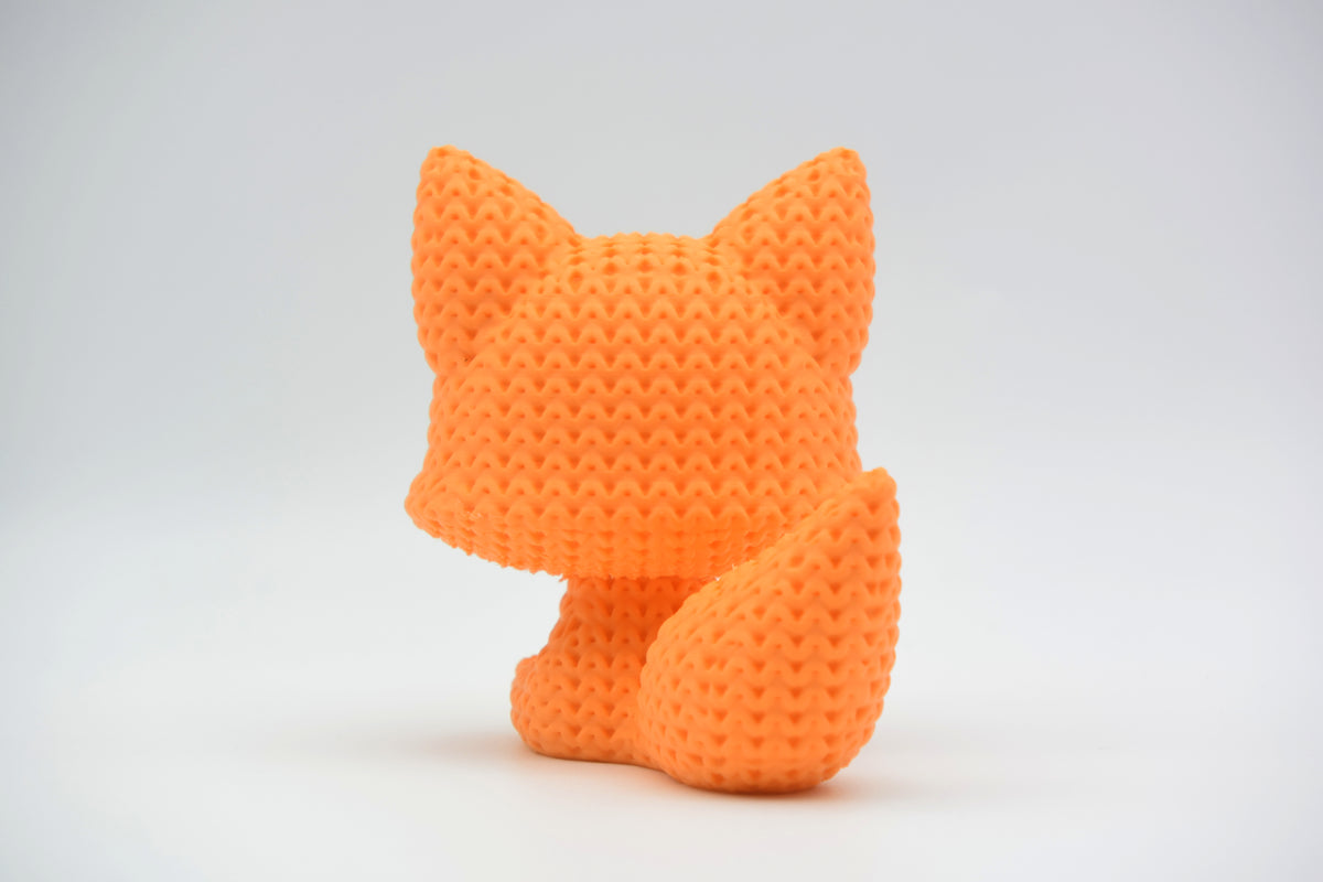 Détail de texture d'une figurine renard façon tricot avec doux motif de boucles crochetées