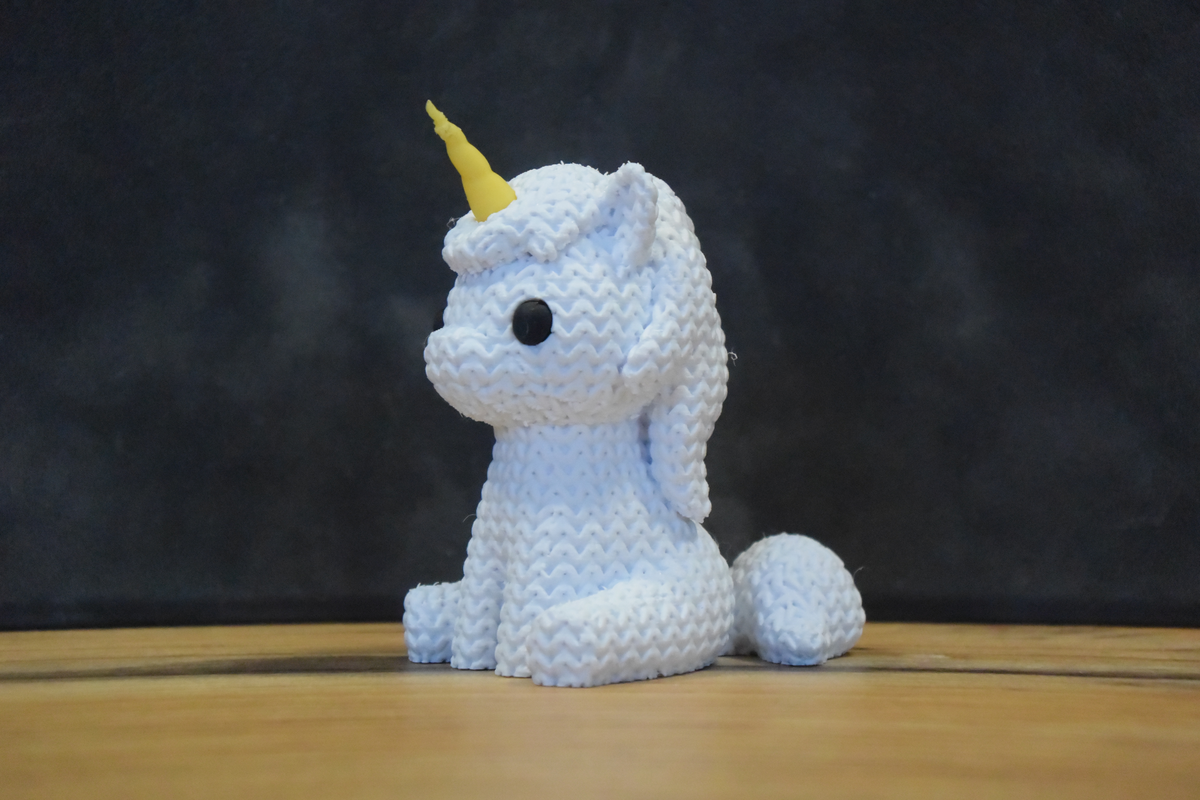 Détail de texture d'une licorne façon tricot au doux motif tissé, aspect cousu main