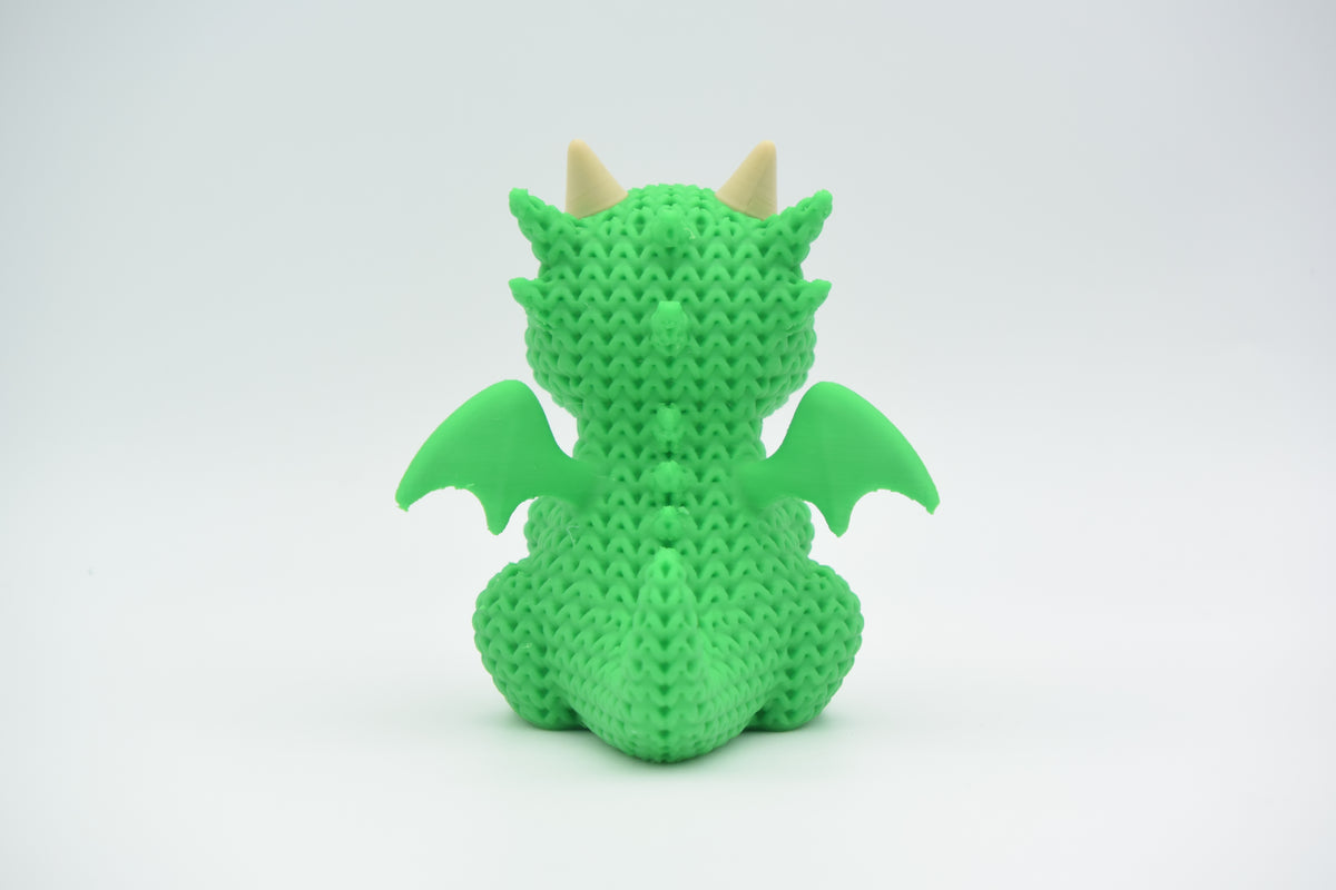 Gros plan du motif à boucles crocheté d'un dragon tricoté
