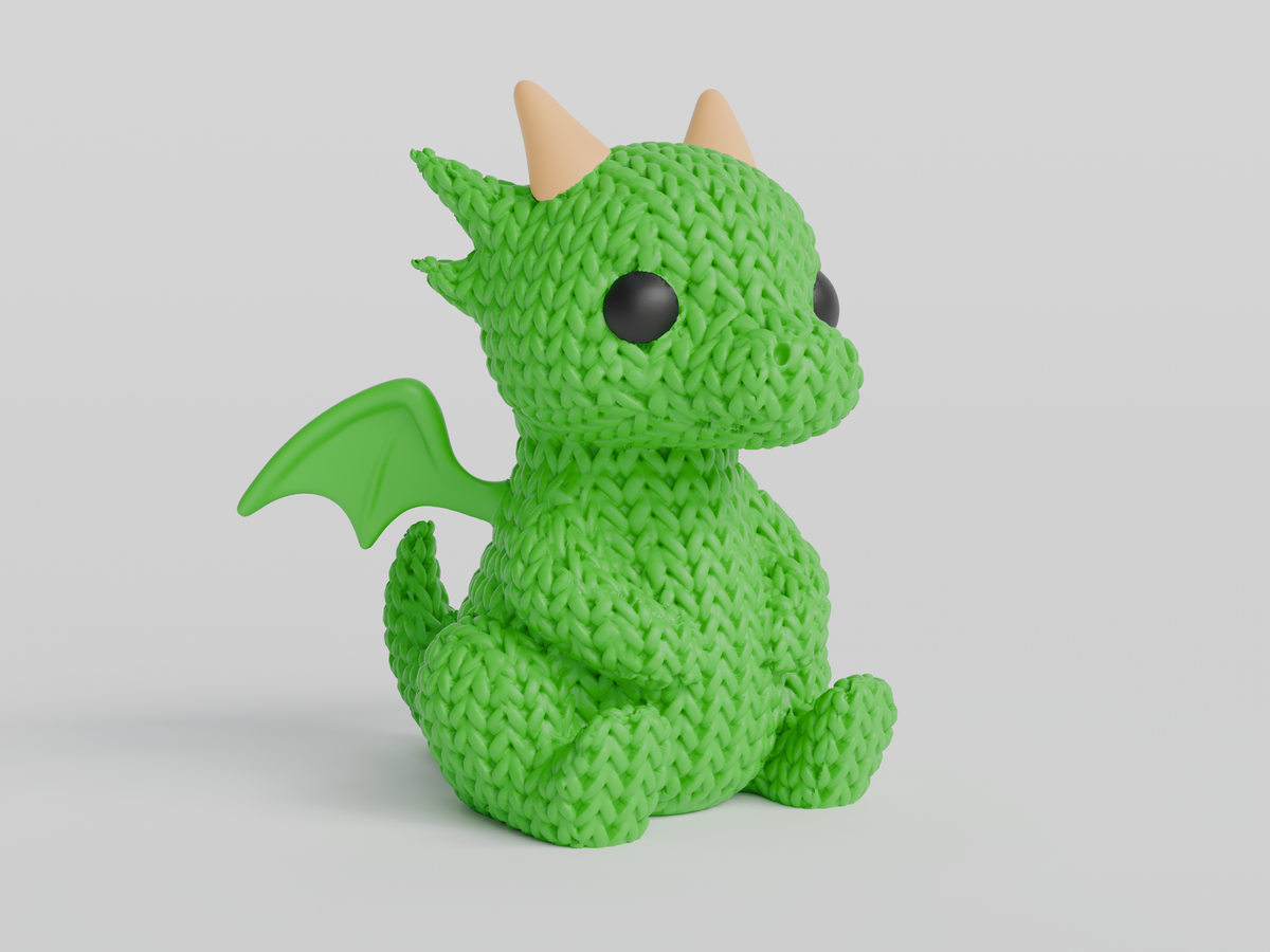 Gros plan d'une figurine de dragon tricoté à texture crochetée sur fond clair