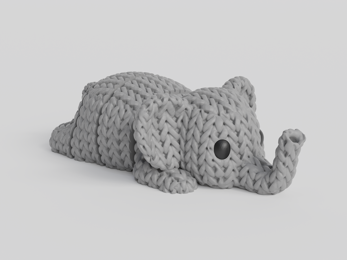 Gros plan d'un porte-clés éléphant tricoté à texture crochetée et corps articulé