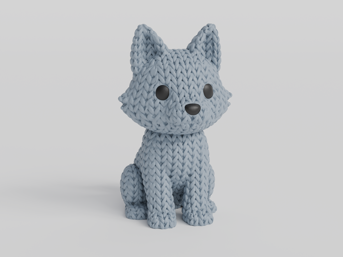 Gros plan d'une figurine de loup tricoté gris chaud à texture crochetée, env. 10 cm de haut