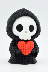 Gros plan d'une Faucheuse crochetée avec un petit cœur et une douce texture tricotée
