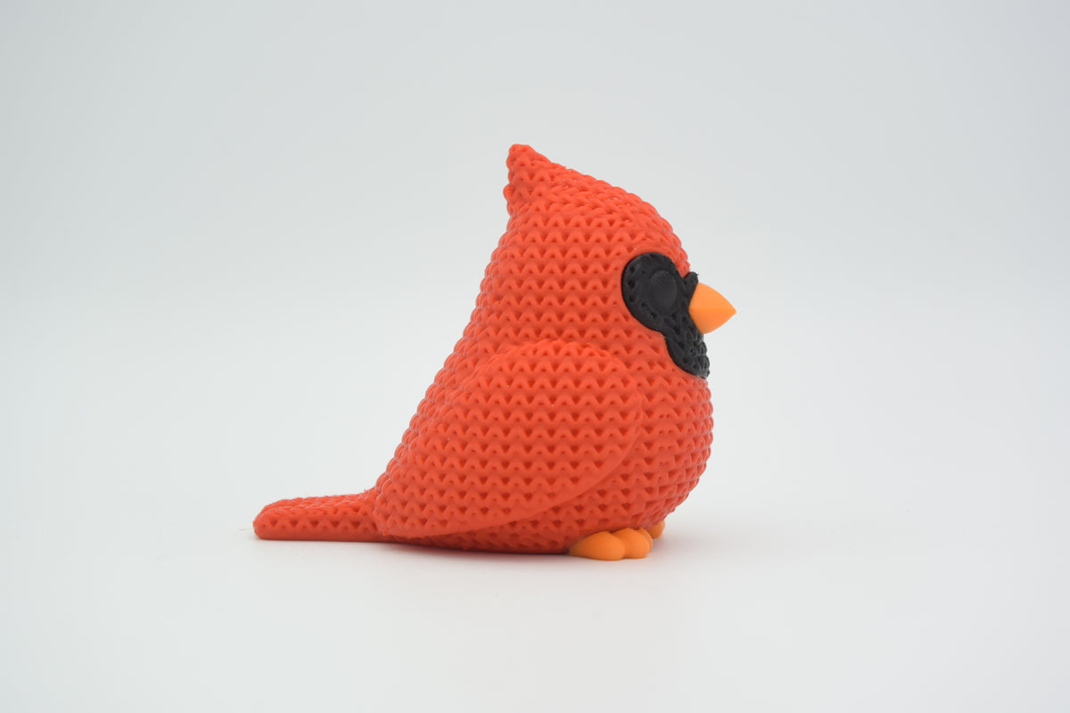 Détail de texture du cardinal avec un fin motif tricoté sur le corps rouge