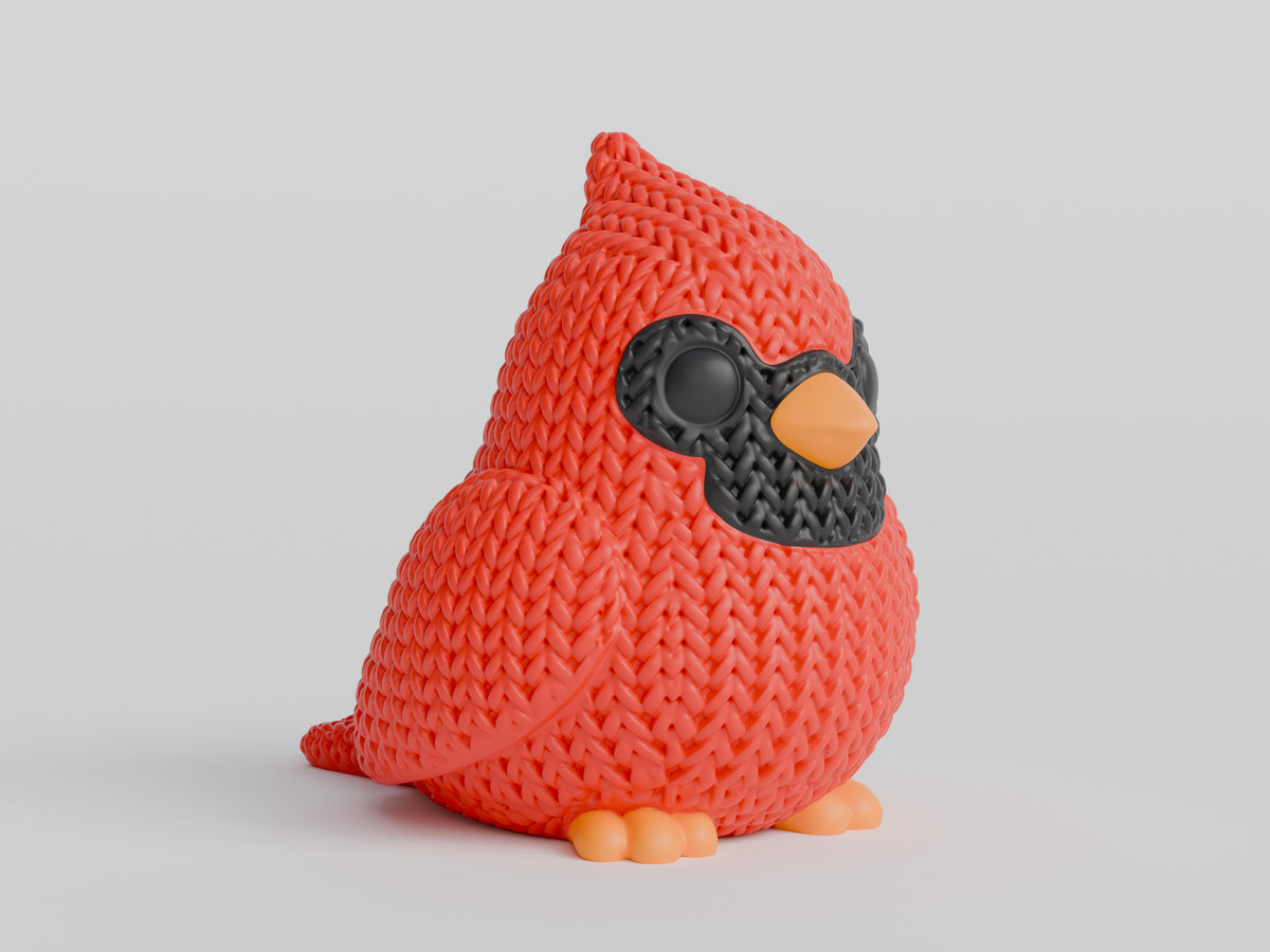 Gros plan d'un cardinal tricoté à texture crochetée rouge et marques faciales sombres