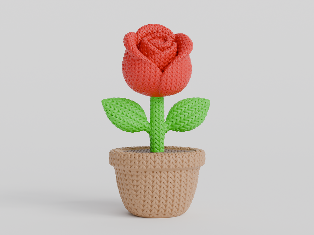 Gros plan d'une rose tricotée décorative aux pétales doux dans des tons rouges chaleureux
