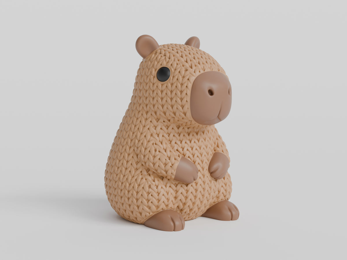 Gros plan d'une figurine de capybara tricoté dans des tons bruns chauds, texture crochetée