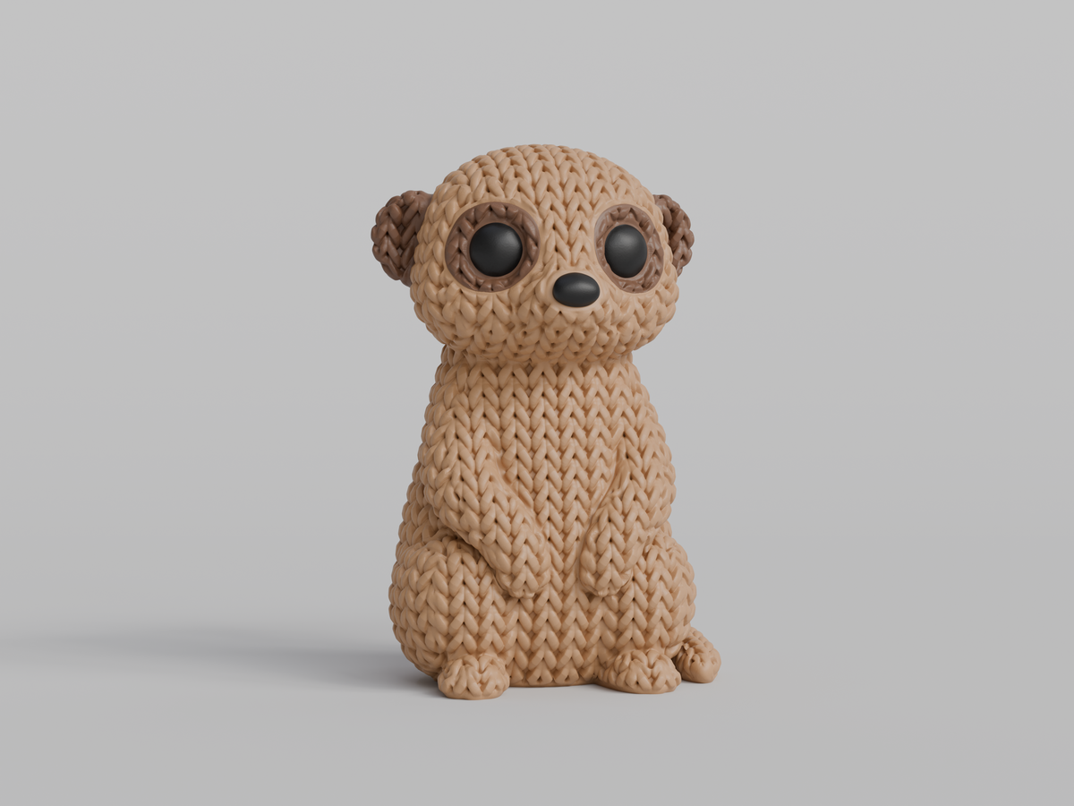 Gros plan d'une figurine de suricate tricoté à texture crochetée, debout sur fond blanc