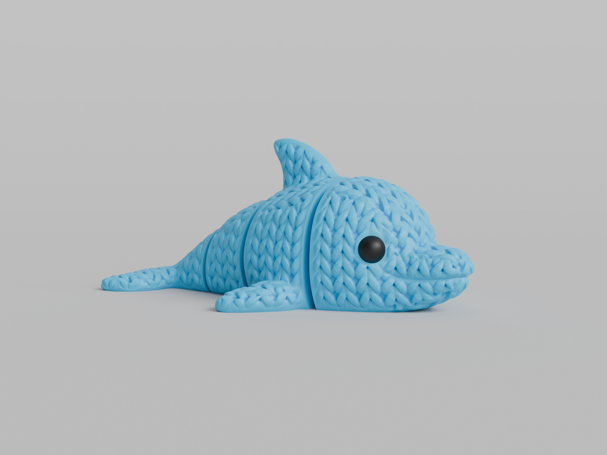 Gros plan d'une figurine de dauphin tricoté articulé gris clair, texture crochetée
