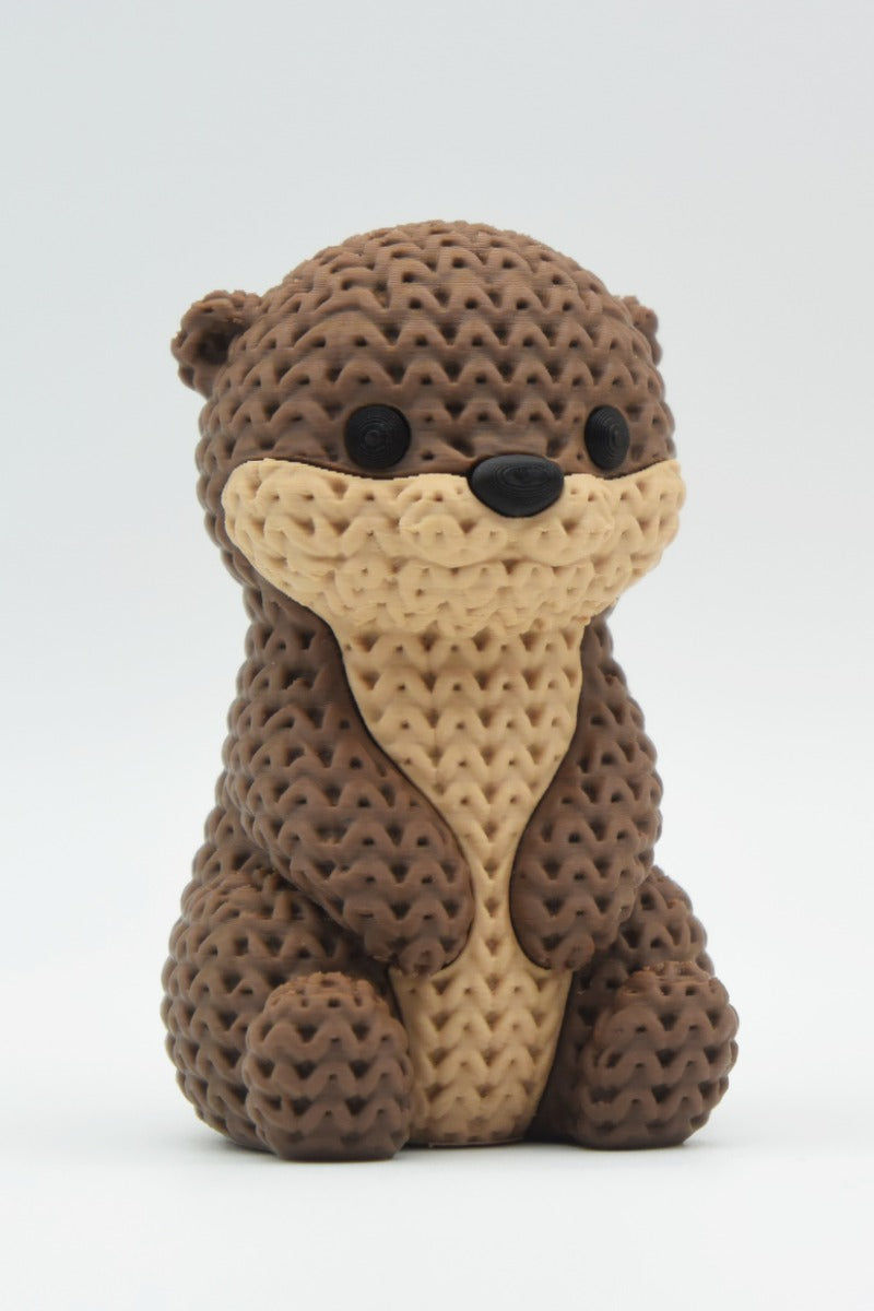 Gros plan d'une figurine de loutre tricotée à la douce texture crochetée et au visage détaillé
