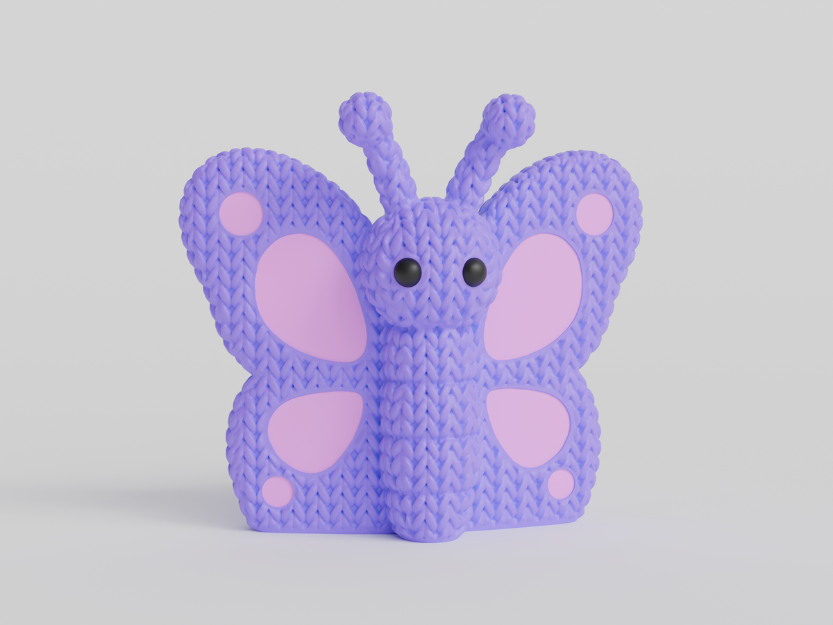 Gros plan d'un papillon tricoté aux ailes crochetées dans des couleurs chaudes